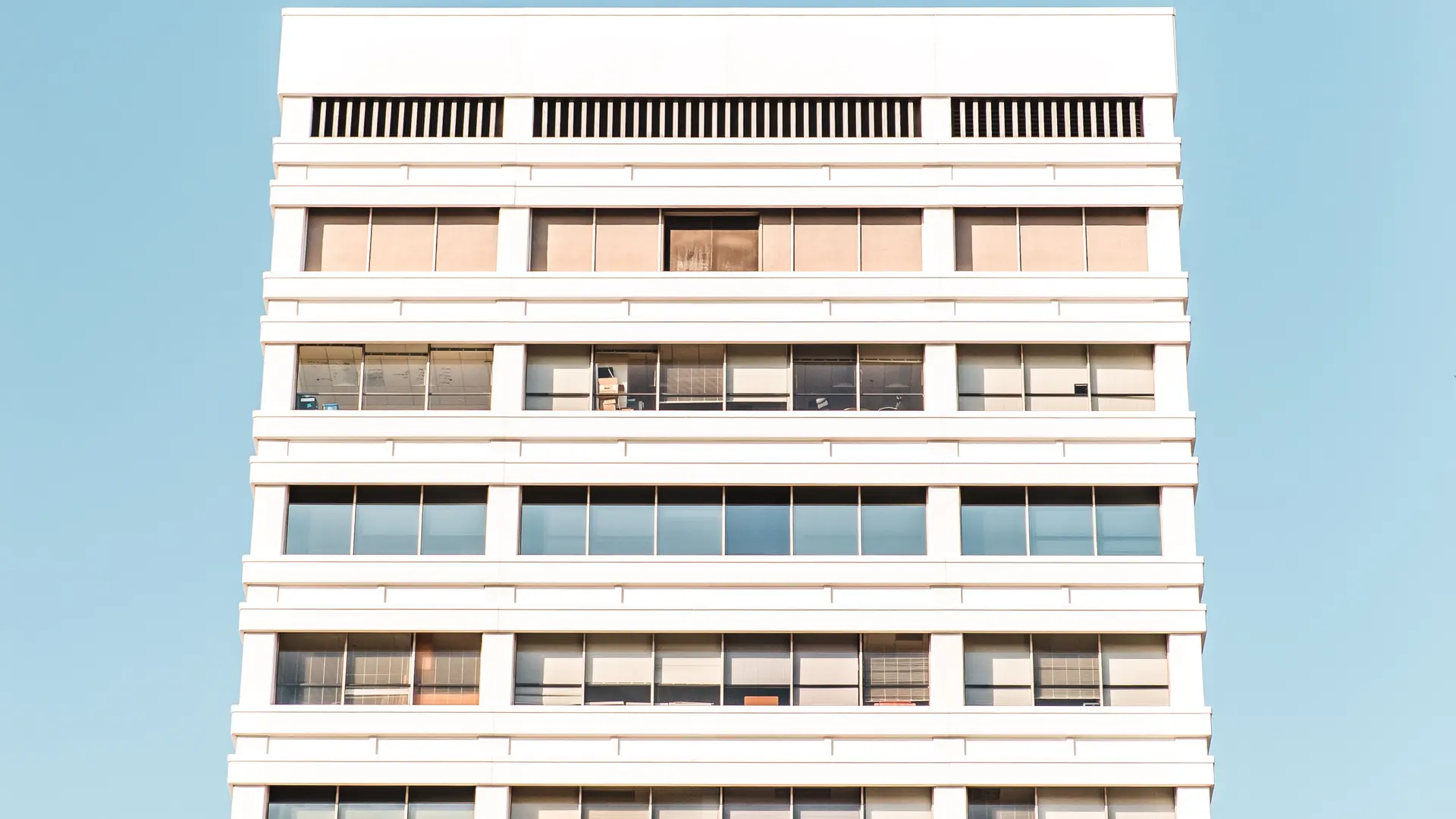 A single apartment block on a street.